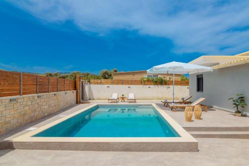 a swimming pool in the backyard of a house at Allegra Villa in Kypseli