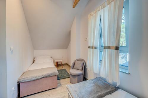 sypialnia z 2 łóżkami i oknem w obiekcie PROFIL Family House w Pogorzelicy