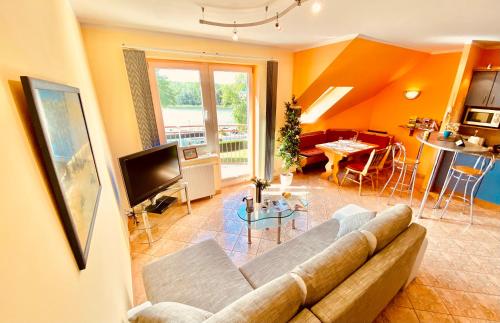 salon z kanapą i telewizorem w obiekcie Sonnige Maisonette-Wohnung mit Blick auf die Bucht w Dziwnowie