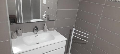 a bathroom with a white sink and a mirror at Villa Maria in Marconia