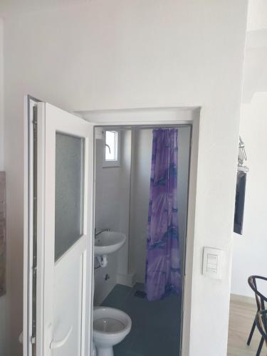 a bathroom with a toilet and a sink at Apartments Sole in Sutomore