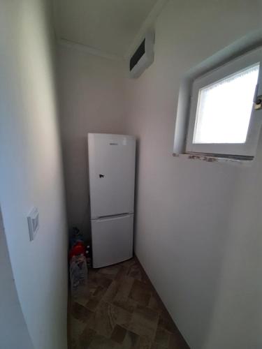 a small room with a refrigerator and a window at All-in-a good space in Budapest