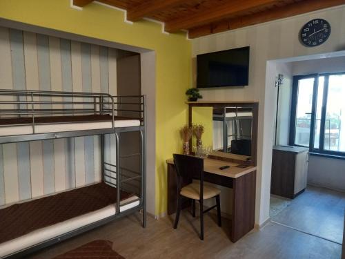 a room with bunk beds and a desk with a computer at Stariya oreh pool & garden in Vidin