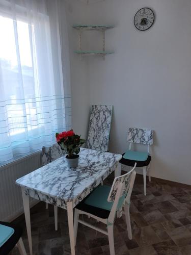 a dining room with a table and two chairs at All-in-a Good Space in Budapest