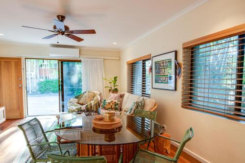 a living room with a glass table and chairs at The Nightcliff Casinha - Boutique Coastal Retreat in Nightcliff