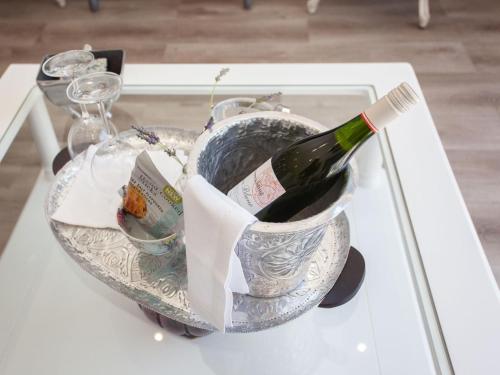 a bottle of wine in a bowl on a table at No 4 Boutique Beach House in Summerstrand