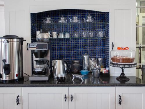 a kitchen with a counter top with a coffee maker at No 4 Boutique Beach House in Summerstrand