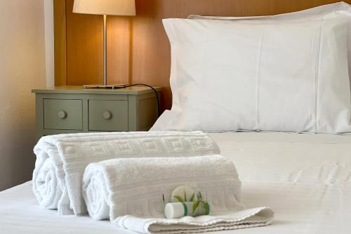 a white bed with towels and a stuffed animal on it at Praia do Vau by amcf in Portimão