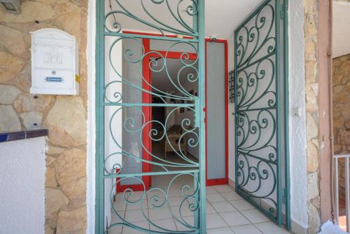an open door with a metal gate next to a building at Port 27 in Empuriabrava
