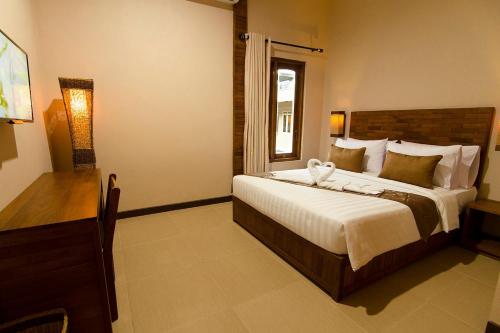 Postelja oz. postelje v sobi nastanitve Syailendra Hotel Syariah