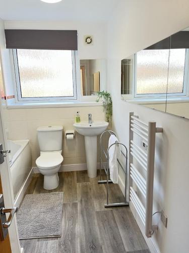 a bathroom with a toilet and a sink at Bright 2 Bedroom Apartment - Edinburgh in Edinburgh