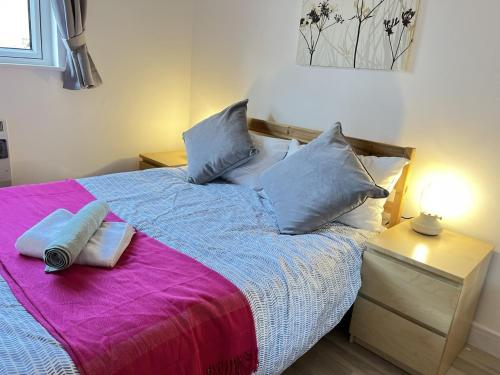 a bedroom with a bed with two pillows on it at Bright 2 Bedroom Apartment - Edinburgh in Edinburgh