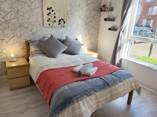 a bedroom with a bed with two stuffed animals on it at Bright 2 Bedroom Apartment - Edinburgh in Edinburgh