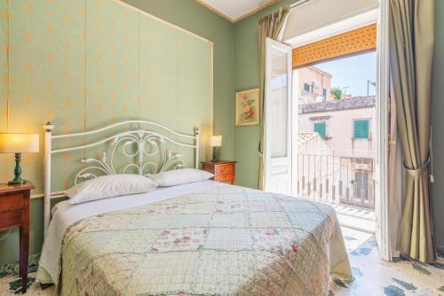 a bedroom with a bed and a large window at Casa Neathon - Whole House 14 guest in Noto