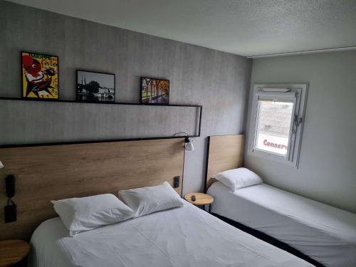 a bedroom with two beds and a window at ibis Bayonne Centre in Bayonne