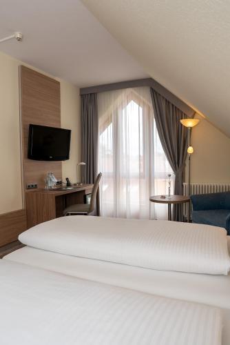 Ένα ή περισσότερα κρεβάτια σε δωμάτιο στο Hotel Kastanienhof