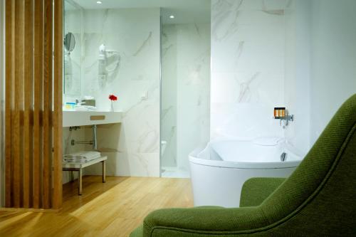 a bathroom with a tub and a sink at Talayot - Adults Only in Cala Millor