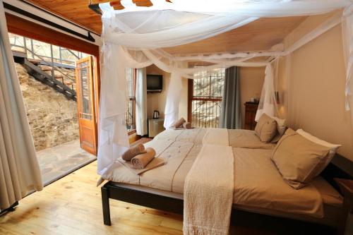 a bedroom with a bed with a canopy at Ti Melen Boutique Guesthouse in Windhoek
