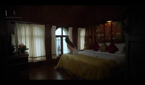 a bedroom with a bed and a window at Kumarakom Lake Resort in Kumarakom