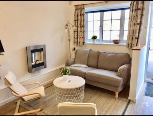 a living room with a couch and a table at Great price, lovely comfy flat.2 mins from the sea in Lyme Regis
