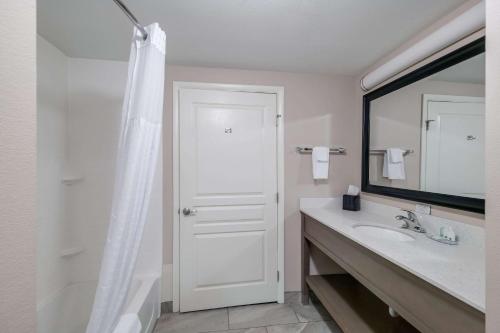 a white bathroom with a sink and a mirror at Quality Inn & Suites Ardmore in Ardmore