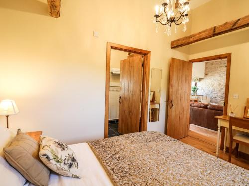 a bedroom with a bed and a living room at Golwg Las in Llanwrda