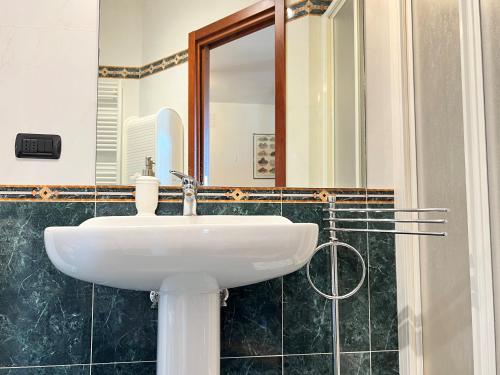 a bathroom with a white sink and a mirror at Provenzano Studios in Siena