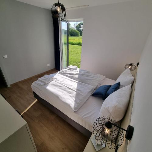 a bedroom with a bed with a window in it at Apartamenty Boczna 3B z sauną i balią in Kudowa-Zdrój