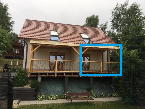 a house with a blue frame on the side of it at Bieszczadzki Hals - Dom bliźniak in Polańczyk