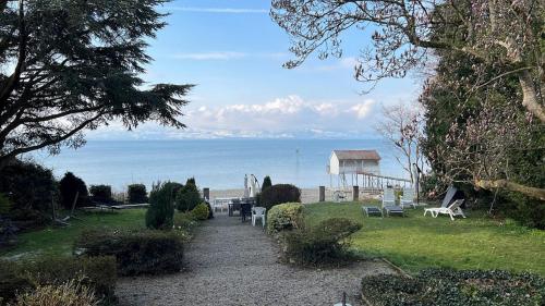 a path leading to a beach with a house and the ocean at Villa Gerster in Wasserburg am Bodensee