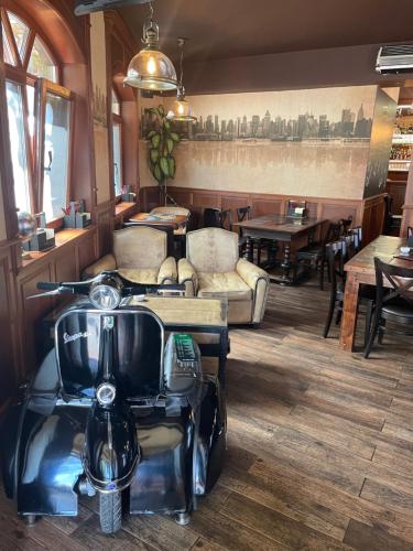 a restaurant with a scooter in the middle of a room at New York Pension in Dunajská Streda