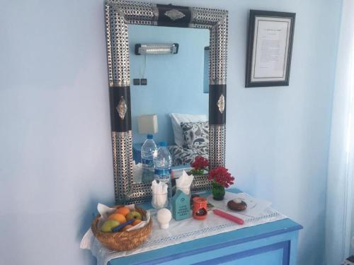 a bathroom vanity with a mirror and a basket of fruit at Pretty room in villa Lair De La Mer, in Sidi Kaouki in Sidi Kaouki