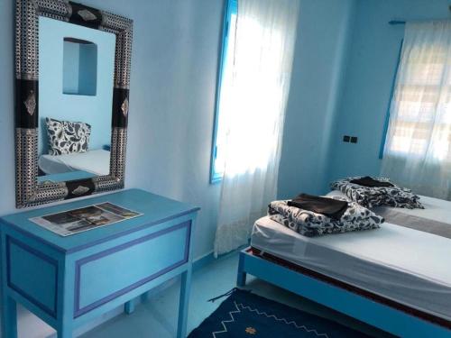 a blue bedroom with a bed and a mirror at Pretty room in villa Lair De La Mer, in Sidi Kaouki in Sidi Kaouki