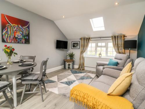 a living room with a couch and a table at New Inn Apartment in York
