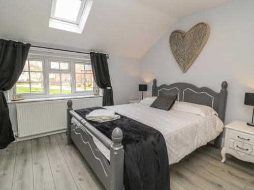 a bedroom with a bed and a heart on the wall at New Inn Apartment in York