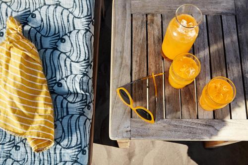 two glasses of orange juice on a wooden table at TUI MAGIC LIFE Sarigerme in Sarigerme
