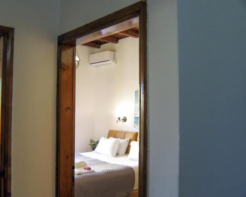 a mirror reflection of a bedroom with a bed at Casa Dasyra in Chania Town