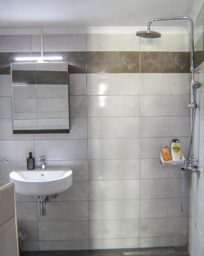 a bathroom with a sink and a shower at Casa Dasyra in Chania Town