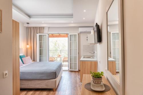 a hotel room with a bed and a kitchen at KORINA APART HOTEL KAVOS in Kavos
