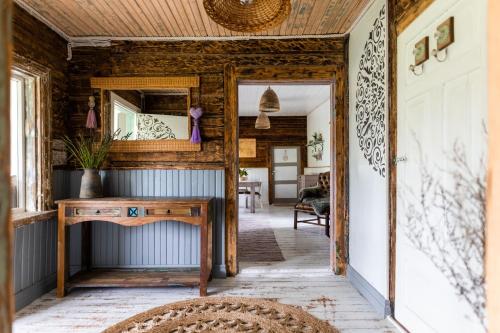 a hallway with a mirror and a wooden wall at Lõuka Farm House in Maasi