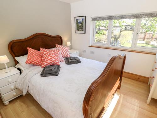 a bedroom with a bed with two towels on it at Garden Cottage in Ilkley