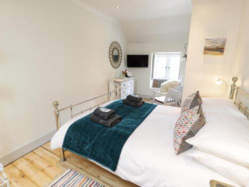 a bedroom with a large white bed in a room at Swn yr Afon in Caernarfon