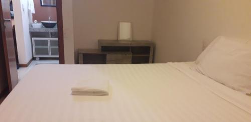 a white bed with a napkin on top of it at Privileg in Ilhéus