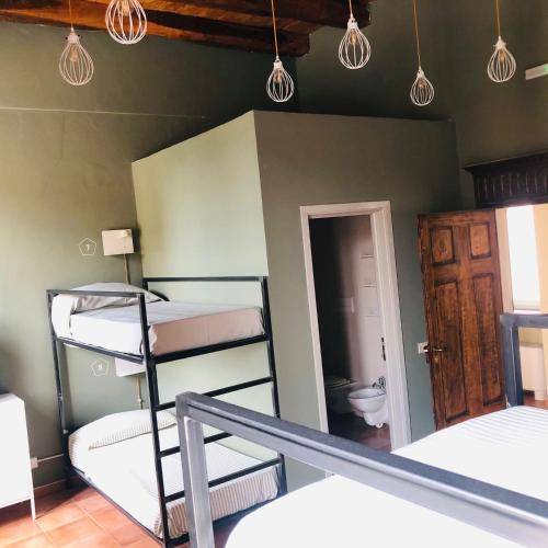 a room with bunk beds and a bathroom with a toilet at Casa Conte Rosso in Avigliana