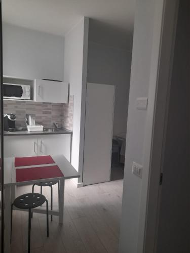 a kitchen with a table and two stools in a room at Your Independent Room with parking in Lecco