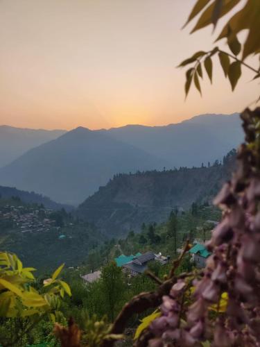 a view of a mountain range at sunset at Ikigai Manali in Nagar