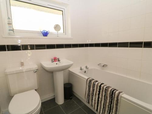 a bathroom with a toilet and a sink and a bath tub at Ballasalla in Liskeard