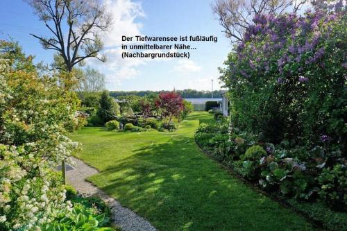 a garden with flowers and a quote about gardening at Ferienhaus "Brigitte" Objekt ID 12053-4 in Waren