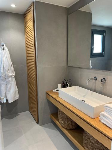 a bathroom with a white tub and a sink at MARAVILLA SUITES in Paleo Tsifliki