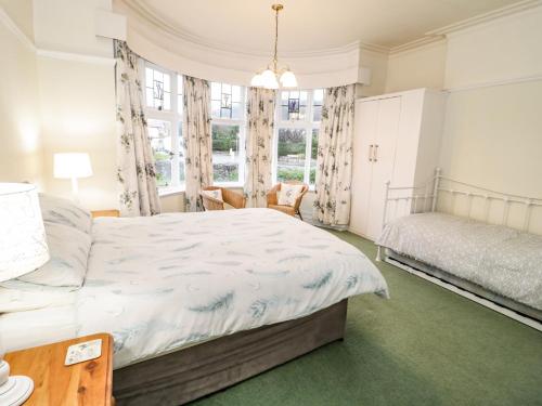 a bedroom with a bed and a window at Seawinds in Colwyn Bay